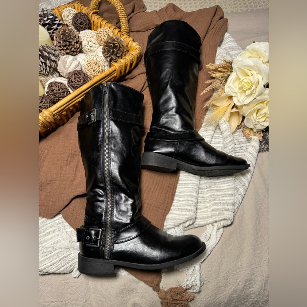 Brash black knee high boots.